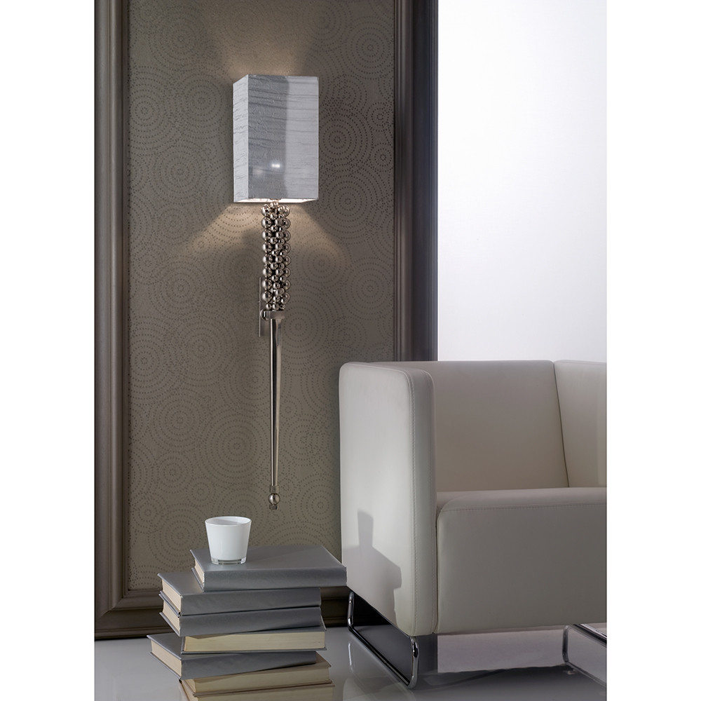 Hand forged iron and brass wall lamp, with brushed, chromed finish.
Double “lux” silk lampshade over silver foil.